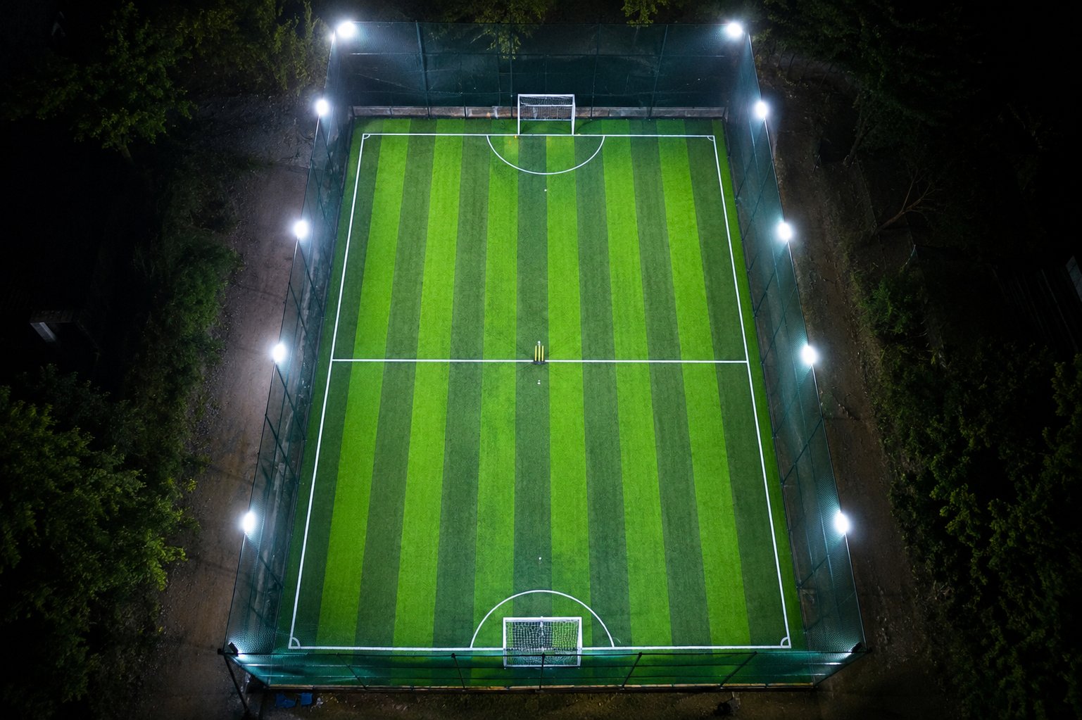 Aerial drone view of The Turf X pitch at night