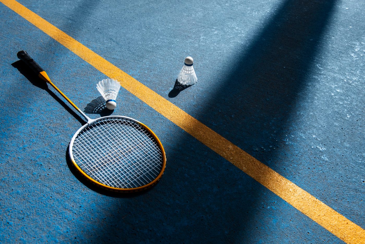 Badminton racket and shuttlecocks on court