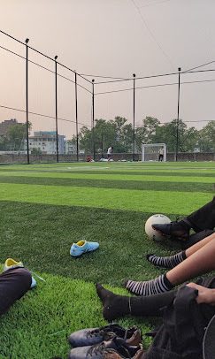 Players resting after a match at dusk at The Turf X