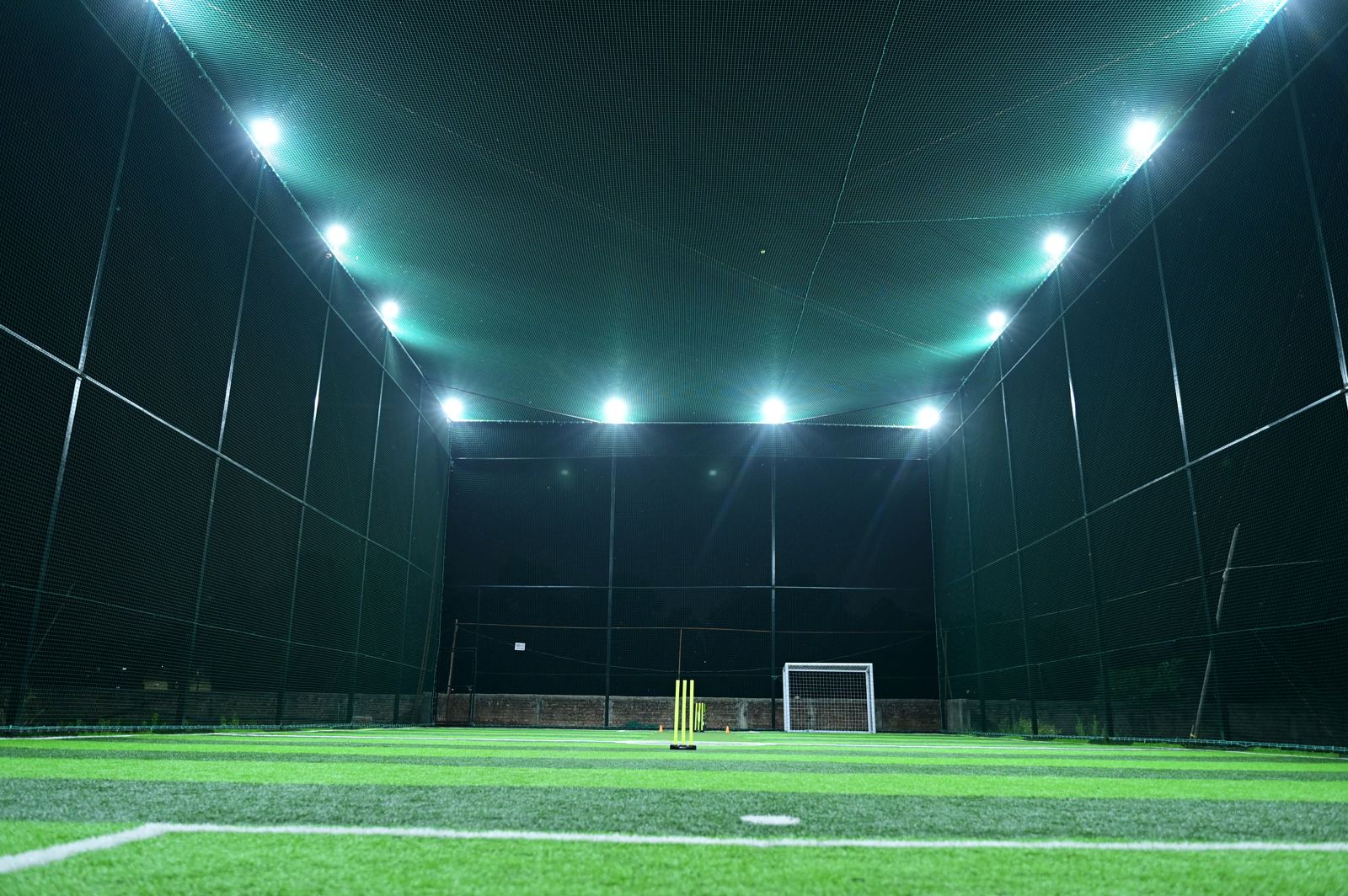 The Turf X enclosed box cricket arena under floodlights